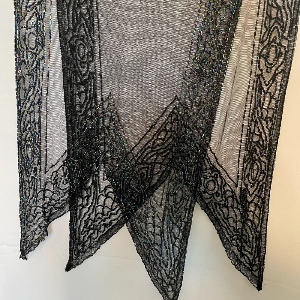 Black see through shawl with rainbow beaded accent around.​​​​​​​​​​​​​